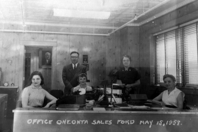 Office staff, from left: Theresa Leslie, Sidney Levine, Janice Scharr, Beatrice Blanding, Florence Disbrow. (c.1957) On the back wall, a picture of the late Riley J. Warren is featured.